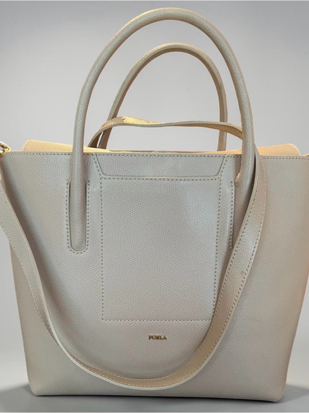 This Furla Astrid tote bag in beige features a textured leather finish.